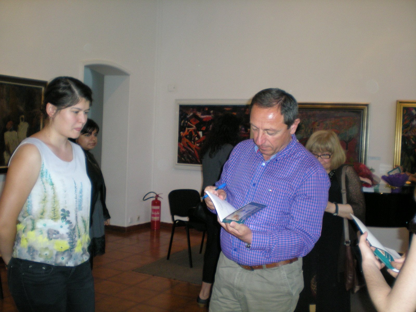 Signing copies in an art gallery