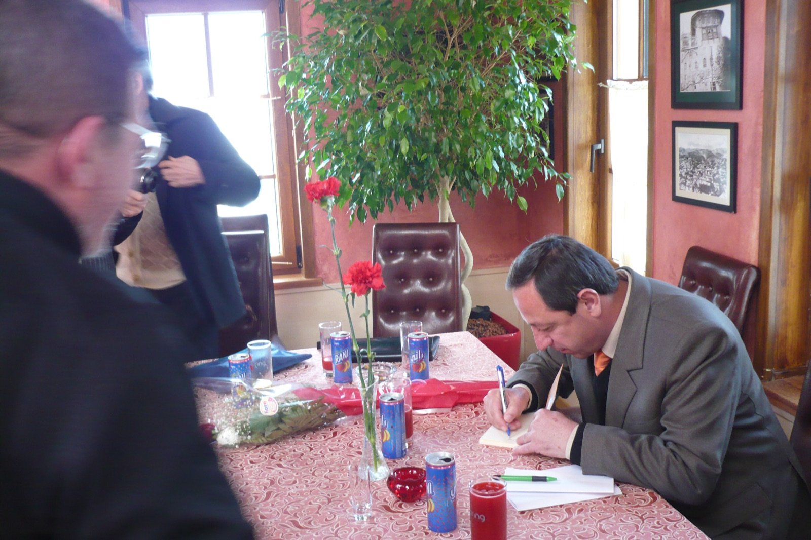 Signing copies at a book launch